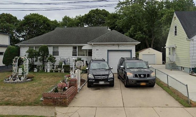 92 Fir St, Valley Stream, NY 11580 - view of front of house featuring driveway, a garage, a shingled roof, and an outdoor structure