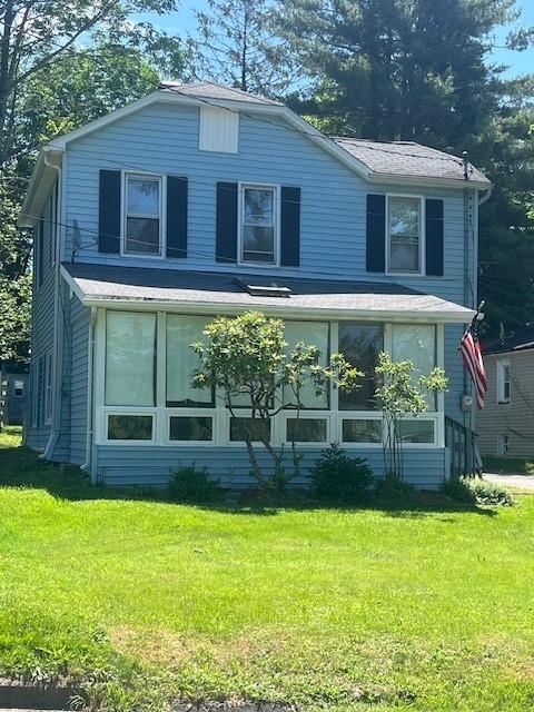 39 Winslow Pl, Liberty, NY 12754 - view of front of home with a front lawn and a sunroom