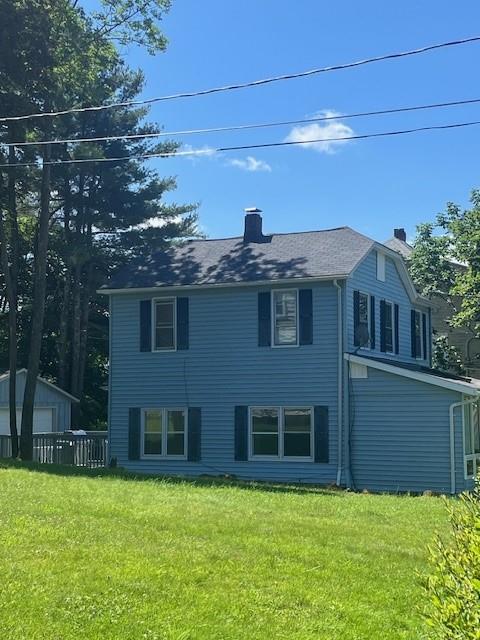 39 Winslow Pl, Liberty, NY 12754 - rear view of property featuring a chimney, a lawn, and an outdoor structure