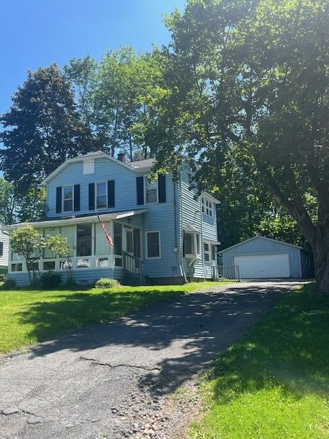 39 Winslow Pl, Liberty, NY 12754 - view of front of property with a detached garage, an outbuilding, and a front lawn