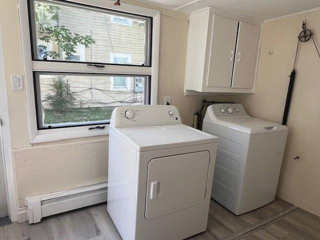 39 Winslow Pl, Liberty, NY 12754 - laundry room with a baseboard heating unit, independent washer and dryer, light wood finished floors, and cabinet space