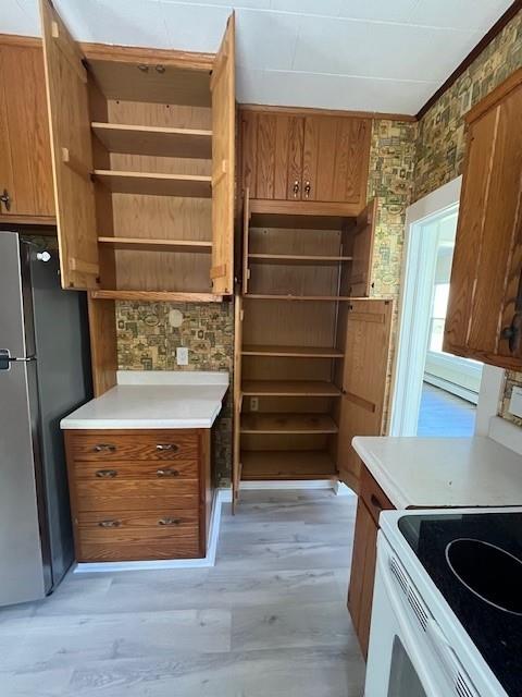 39 Winslow Pl, Liberty, NY 12754 - kitchen featuring freestanding refrigerator, open shelves, brown cabinets, and white electric stove