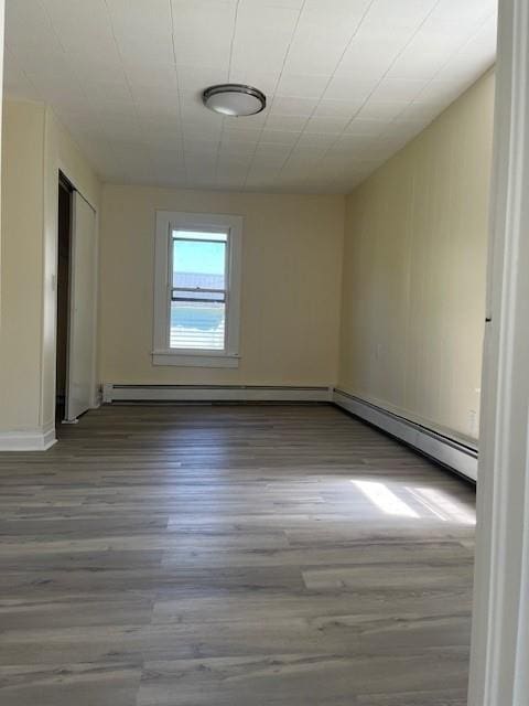 39 Winslow Pl, Liberty, NY 12754 - empty room with a baseboard heating unit, wood finished floors, and a baseboard radiator