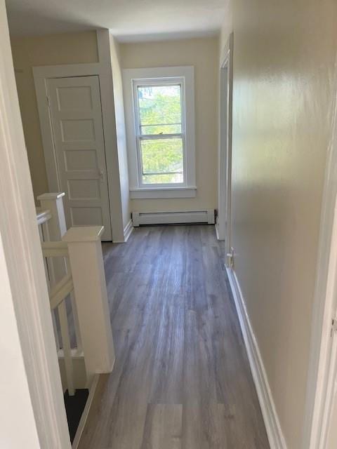 39 Winslow Pl, Liberty, NY 12754 - corridor with a baseboard heating unit and dark wood-style floors