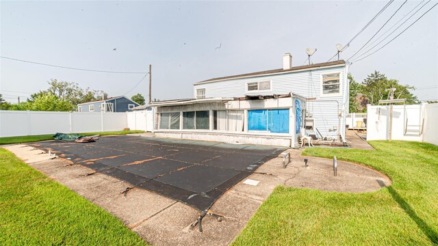 14 Lois Ln, Farmingdale, NY 11735 - rear view of property featuring a fenced backyard, a patio, and a sunroom