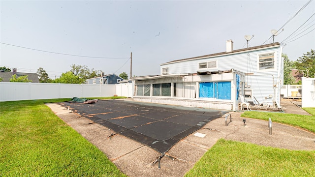 14 Lois Ln, Farmingdale, NY 11735 - back of house featuring a fenced backyard, a patio, a sunroom, and a chimney