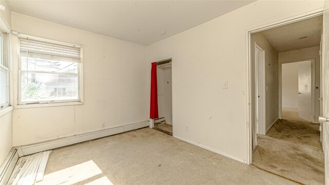 14 Lois Ln, Farmingdale, NY 11735 - unfurnished room with carpet and baseboard heating