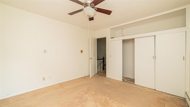 14 Lois Ln, Farmingdale, NY 11735 - unfurnished bedroom featuring light colored carpet, a closet, a ceiling fan, and a textured ceiling