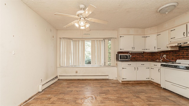 14 Lois Ln, Farmingdale, NY 11735 - kitchen featuring under cabinet range hood, stainless steel microwave, white range with gas cooktop, a textured ceiling, and light wood finished floors