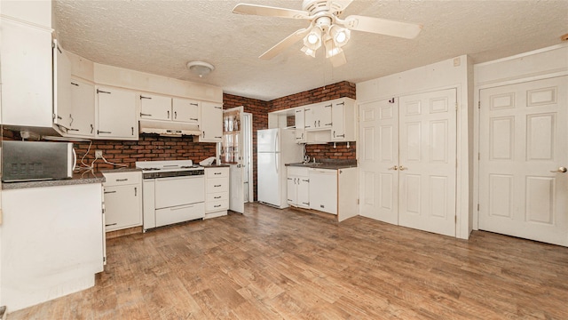 14 Lois Ln, Farmingdale, NY 11735 - kitchen with white appliances, under cabinet range hood, a textured ceiling, white cabinets, and tasteful backsplash