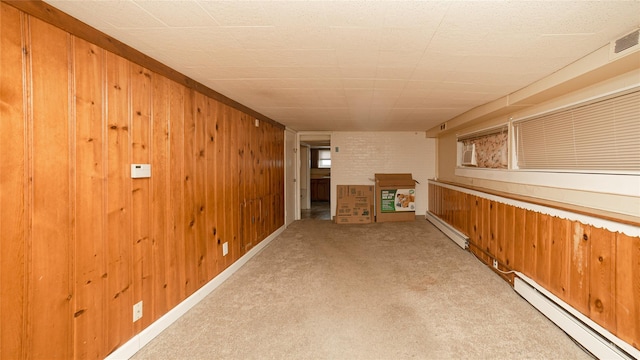 14 Lois Ln, Farmingdale, NY 11735 - hallway featuring a baseboard radiator, carpet, and wood walls