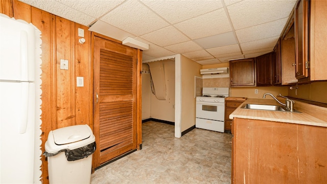 14 Lois Ln, Farmingdale, NY 11735 - kitchen with white appliances, under cabinet range hood, light flooring, light countertops, and a paneled ceiling