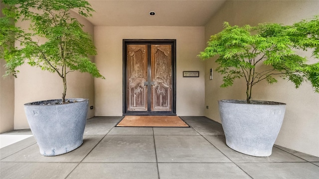 property entrance with french doors and stucco siding