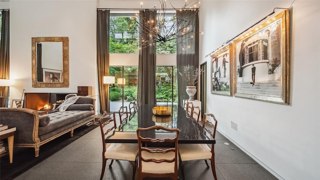 dining space featuring a chandelier and a towering ceiling