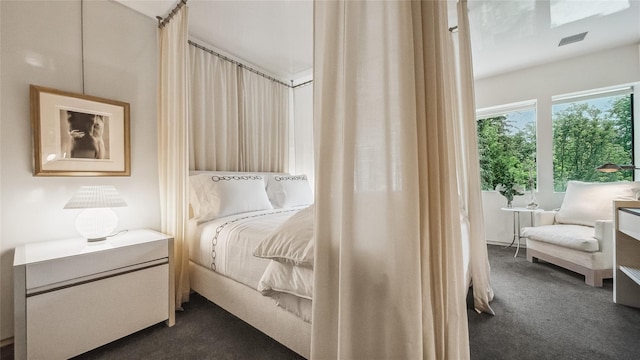 bedroom featuring dark carpet