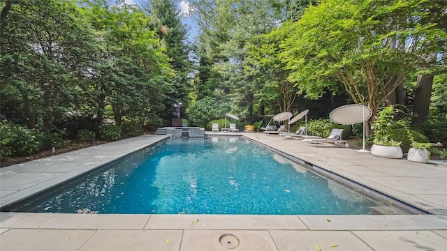 view of pool with a patio and a pool with connected hot tub