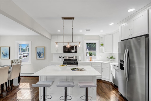 10 Branch Pl, Roosevelt, NY 11575 - kitchen featuring stainless steel appliances, white cabinetry, dark wood-type flooring, light countertops, and recessed lighting