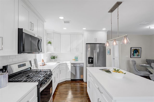 10 Branch Pl, Roosevelt, NY 11575 - kitchen featuring stainless steel appliances, open shelves, decorative backsplash, light countertops, and white cabinets