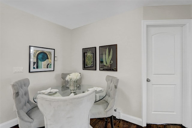 10 Branch Pl, Roosevelt, NY 11575 - dining room featuring wood finished floors and baseboard heating