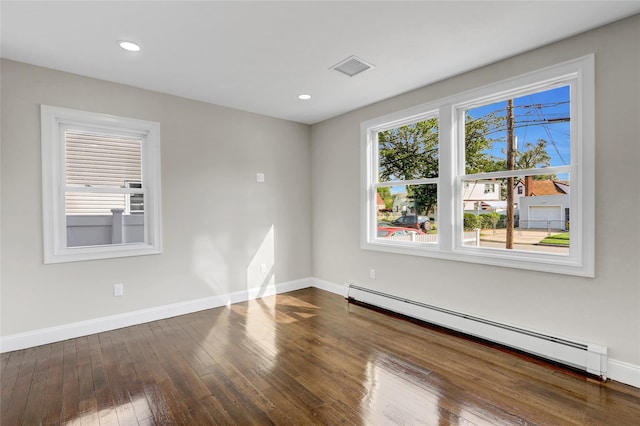 10 Branch Pl, Roosevelt, NY 11575 - spare room featuring a baseboard heating unit, hardwood / wood-style floors, and recessed lighting