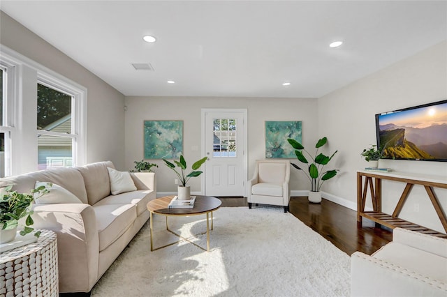 10 Branch Pl, Roosevelt, NY 11575 - living area featuring wood finished floors and recessed lighting