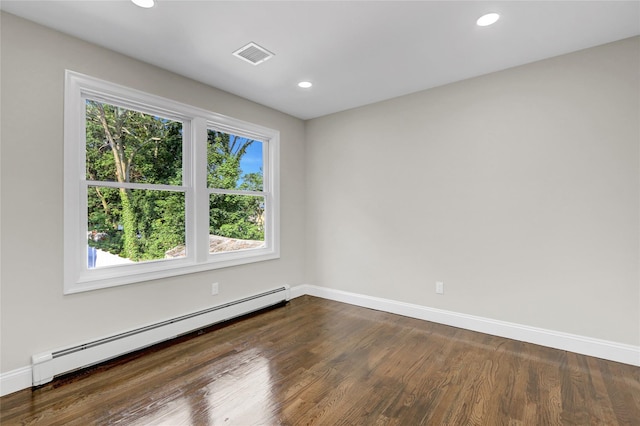 10 Branch Pl, Roosevelt, NY 11575 - empty room featuring a baseboard heating unit, dark wood-style floors, and recessed lighting