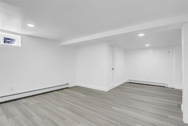 10 Branch Pl, Roosevelt, NY 11575 - finished basement with baseboard heating, recessed lighting, and wood finished floors