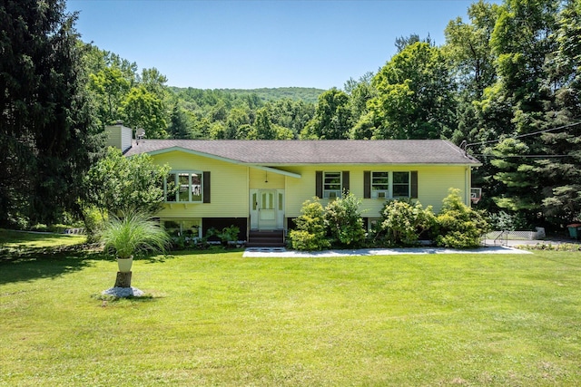 542 Peekskill Hollow Rd, Putnam Valley, NY 10579 - split foyer home with a chimney, a front lawn, a view of trees, and entry steps