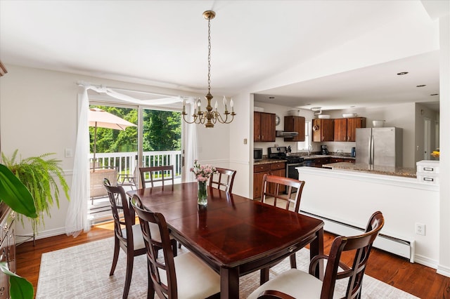 542 Peekskill Hollow Rd, Putnam Valley, NY 10579 - dining space with a chandelier, wood finished floors, baseboard heating, and vaulted ceiling