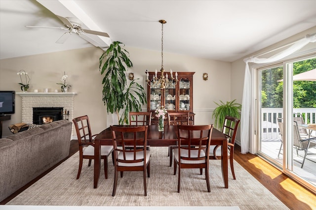 542 Peekskill Hollow Rd, Putnam Valley, NY 10579 - dining room featuring light wood-style floors, lofted ceiling, a brick fireplace, and ceiling fan