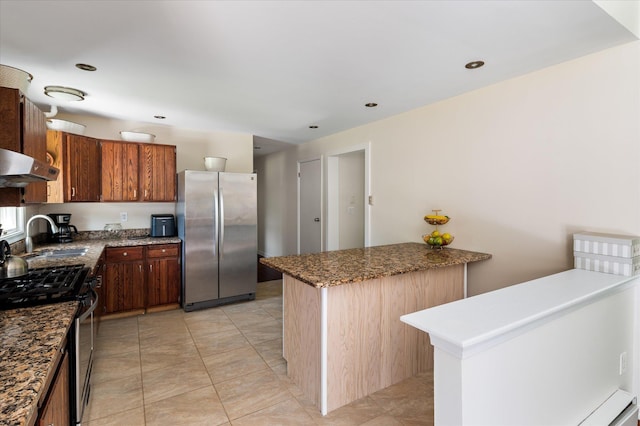 542 Peekskill Hollow Rd, Putnam Valley, NY 10579 - kitchen with stainless steel appliances, under cabinet range hood, light tile patterned flooring, dark stone counters, and a peninsula