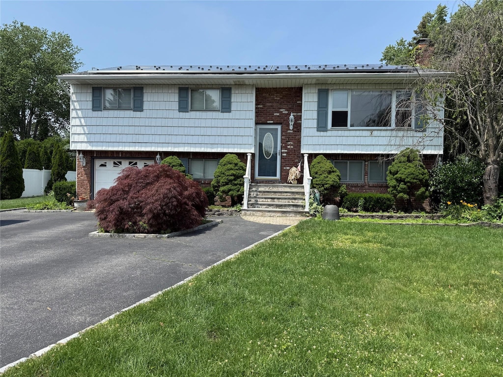 331 Gillette St, Dix Hills, NY 11746 - split foyer home featuring brick siding, a chimney, a garage, a front yard, and asphalt driveway