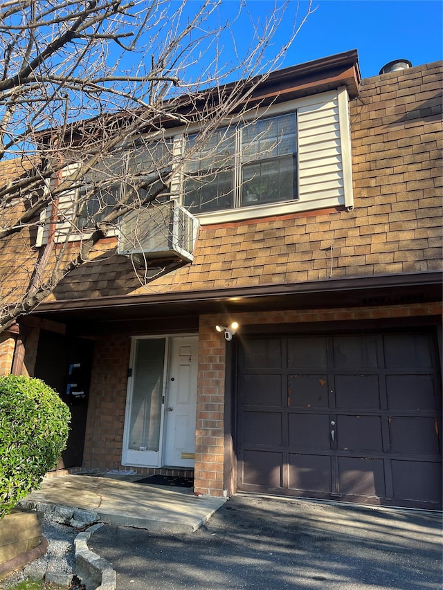 411 121st St Unit 12A, College Point, NY 11356 - multi unit property featuring a garage, brick siding, and a shingled roof
