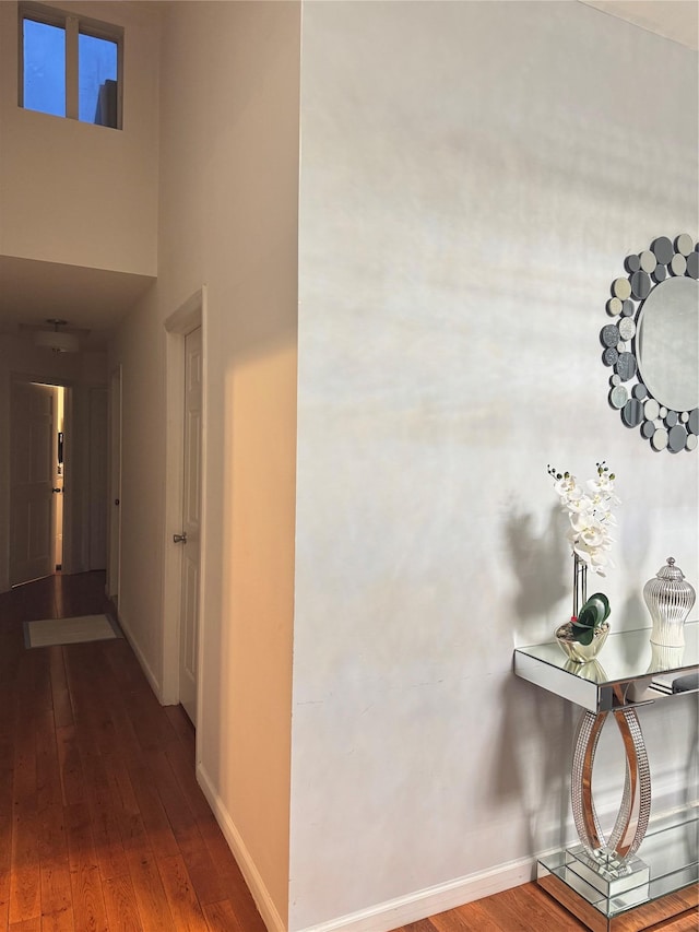 411 121st St Unit 12A, College Point, NY 11356 - hallway featuring hardwood / wood-style floors, a baseboard radiator, and a towering ceiling