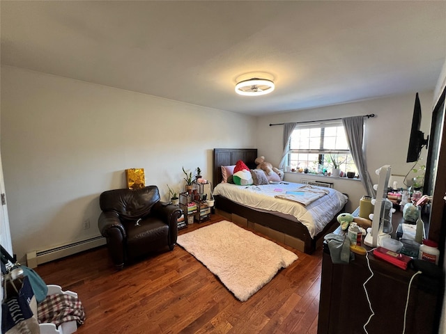 411 121st St Unit 12A, College Point, NY 11356 - bedroom featuring a baseboard heating unit and wood finished floors