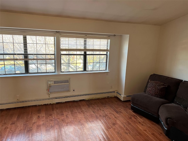 411 121st St Unit 12A, College Point, NY 11356 - unfurnished room with plenty of natural light, wood-type flooring, a wall unit AC, and a baseboard heating unit
