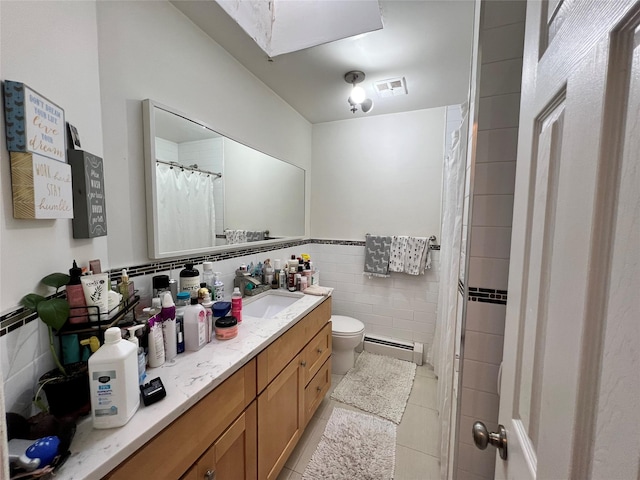 411 121st St Unit 12A, College Point, NY 11356 - full bath with a baseboard heating unit, tile walls, vanity, tile patterned floors, and a skylight