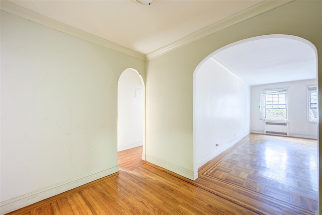 117-01 Park Ln S Unit C5D, Kew Gardens, NY 11415 - unfurnished room with arched walkways, crown molding, and radiator