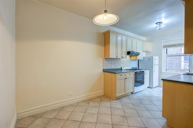 117-01 Park Ln S Unit C5D, Kew Gardens, NY 11415 - kitchen with white appliances, dark countertops, under cabinet range hood, tasteful backsplash, and light tile patterned flooring