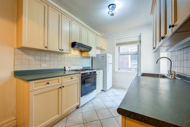 117-01 Park Ln S Unit C5D, Kew Gardens, NY 11415 - kitchen featuring white appliances, extractor fan, dark countertops, light tile patterned floors, and tasteful backsplash