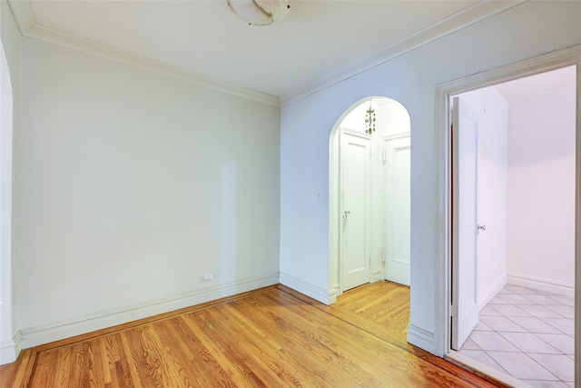 117-01 Park Ln S Unit C5D, Kew Gardens, NY 11415 - spare room with crown molding, arched walkways, and light wood-style floors