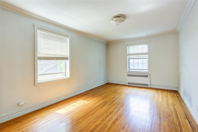 117-01 Park Ln S Unit C5D, Kew Gardens, NY 11415 - spare room featuring radiator, light wood-type flooring, and crown molding