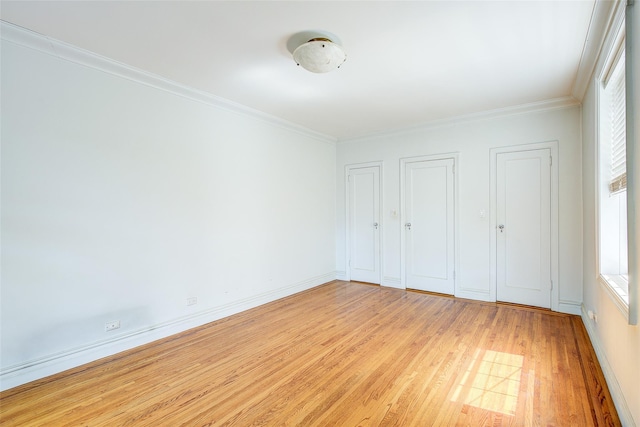 117-01 Park Ln S Unit C5D, Kew Gardens, NY 11415 - unfurnished bedroom featuring light wood-style flooring, two closets, and crown molding