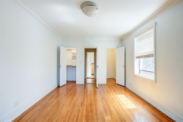 117-01 Park Ln S Unit C5D, Kew Gardens, NY 11415 - unfurnished bedroom with light wood-style flooring, crown molding, and a spacious closet