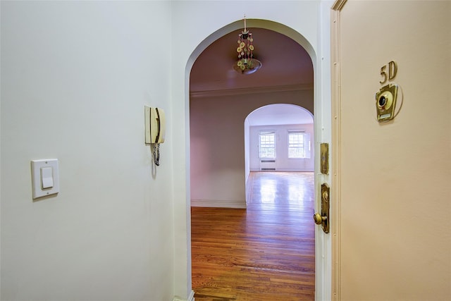 117-01 Park Ln S Unit C5D, Kew Gardens, NY 11415 - hall featuring arched walkways, wood finished floors, and crown molding