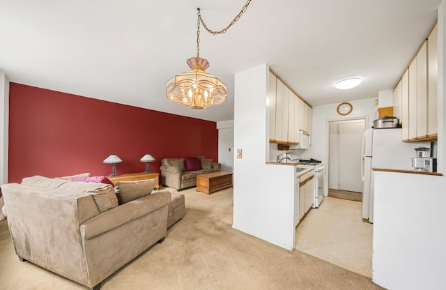 46-01 39th Ave Unit 106, Woodside, NY 11104 - kitchen with light colored carpet, white appliances, a chandelier, and white cabinets