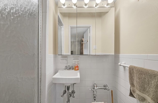 46-01 39th Ave Unit 106, Woodside, NY 11104 - full bathroom with tile walls, a wainscoted wall, and a stall shower