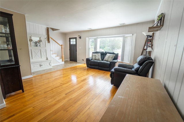 110 Roxbury Dr, Commack, NY 11725 - living area featuring stairway, wood-type flooring, wooden walls, and crown molding