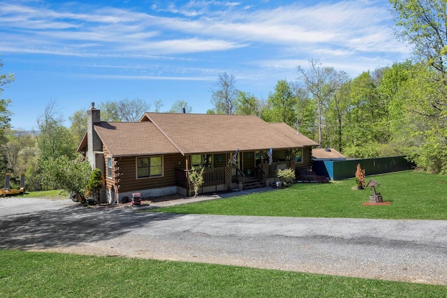 354 Sunset Hill Rd E, Fishkill, NY 12524 - log home featuring a porch, log exterior, a chimney, roof with shingles, and a front yard