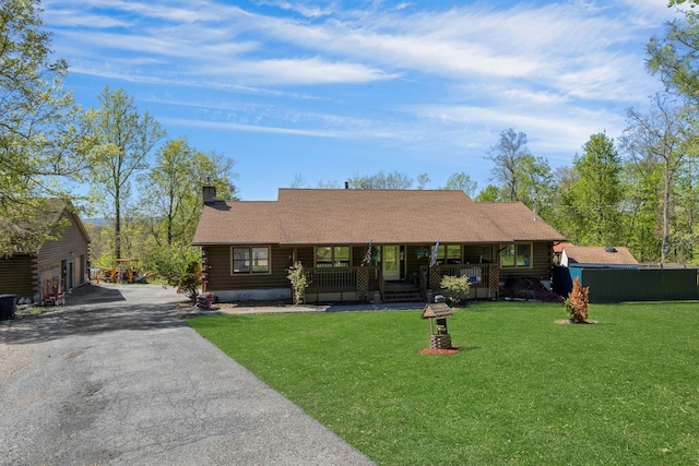 354 Sunset Hill Rd E, Fishkill, NY 12524 - view of front of home with covered porch, log exterior, a chimney, and a front yard